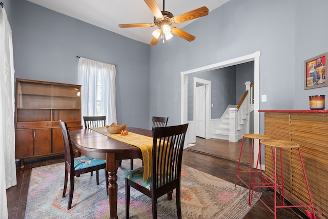 dining room with ceiling fan and dark hardwood / wood-style flooring