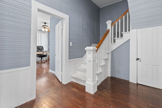 stairway with ceiling fan and hardwood / wood-style flooring