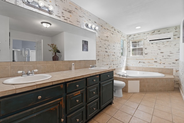 bathroom with a relaxing tiled tub, an AC wall unit, double sink vanity, toilet, and tile patterned flooring