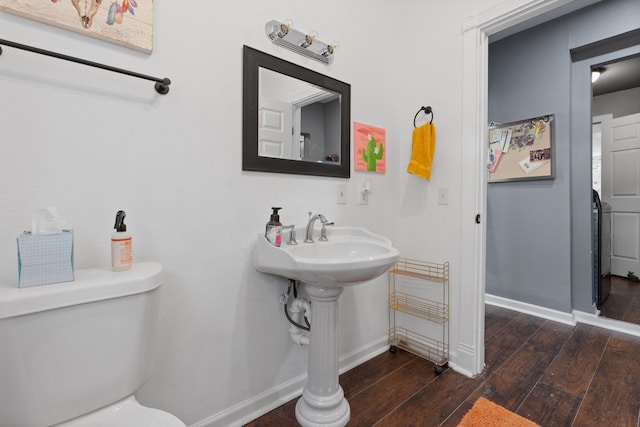 bathroom featuring wood-type flooring and toilet