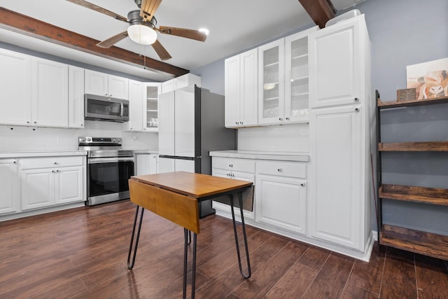 kitchen featuring white cabinets, ceiling fan, glass insert cabinets, dark wood-style flooring, and stainless steel appliances