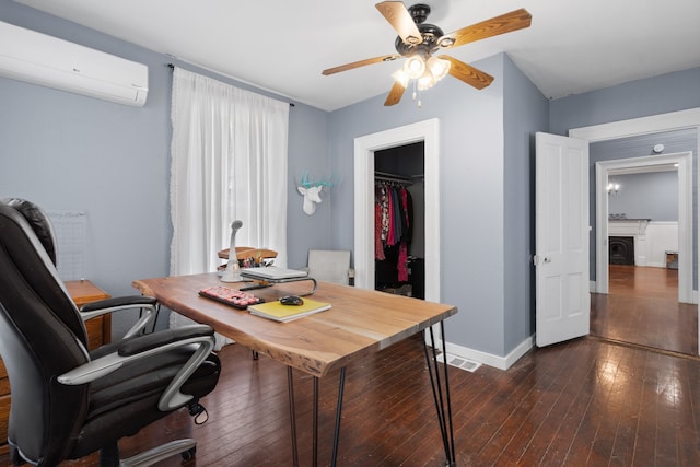 office area featuring ceiling fan, dark hardwood / wood-style flooring, and a wall unit AC