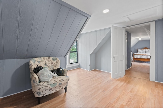 living area with vaulted ceiling and wood finished floors