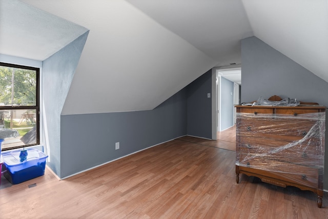 bonus room featuring hardwood / wood-style floors and vaulted ceiling