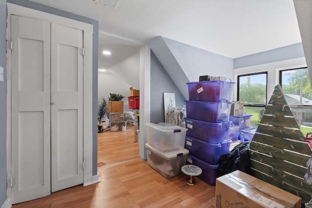 bonus room with light hardwood / wood-style flooring and vaulted ceiling