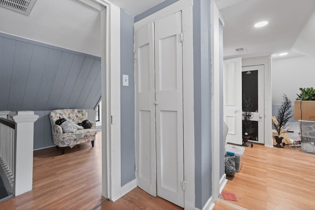 corridor with hardwood / wood-style flooring