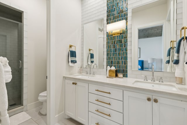 bathroom featuring double vanity, tile patterned flooring, a shower with door, and toilet