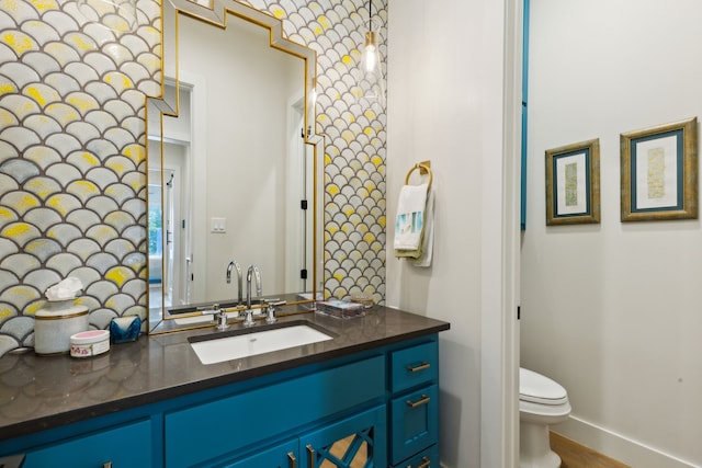 bathroom with toilet and vanity