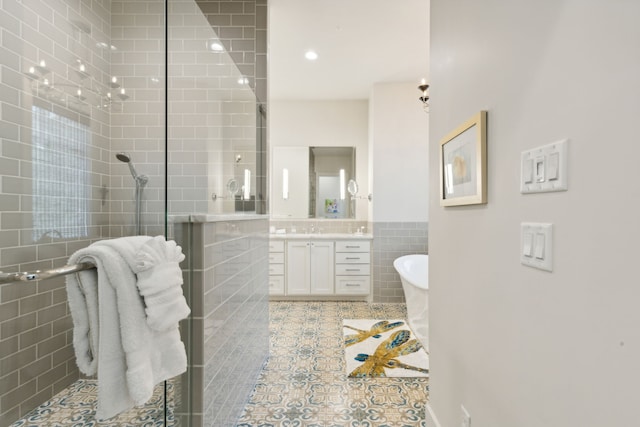 bathroom featuring vanity, tile patterned floors, separate shower and tub, and tile walls