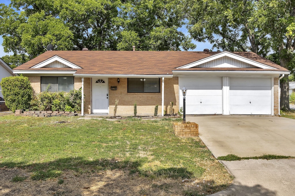 single story home featuring a garage and a front yard