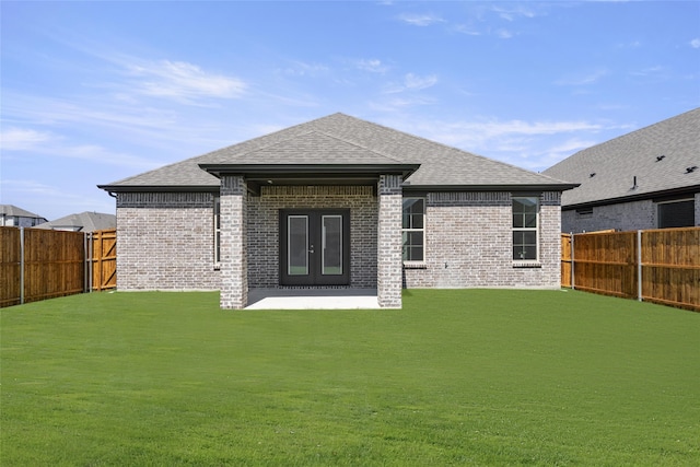 back of house with french doors, a yard, and a patio