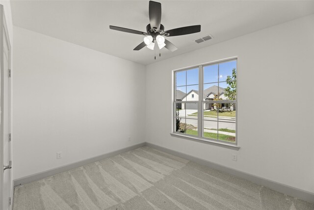 carpeted empty room with ceiling fan