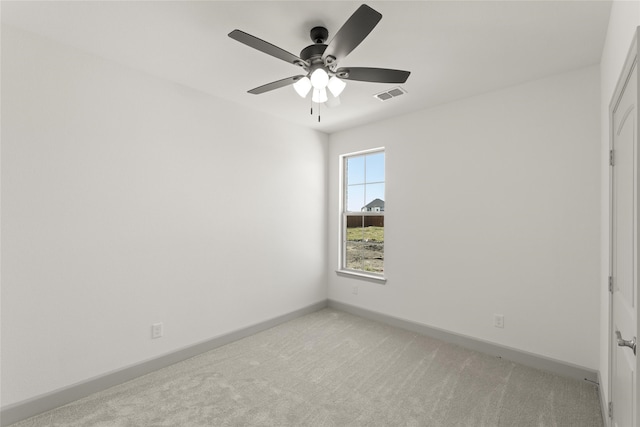 carpeted spare room featuring ceiling fan