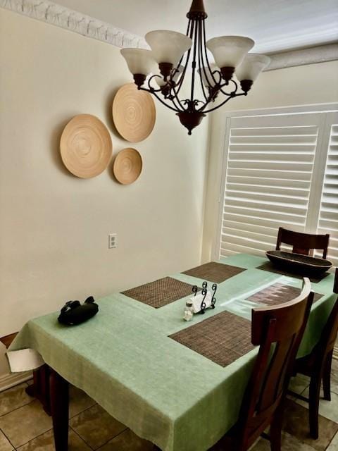 dining room with light tile patterned floors and a notable chandelier