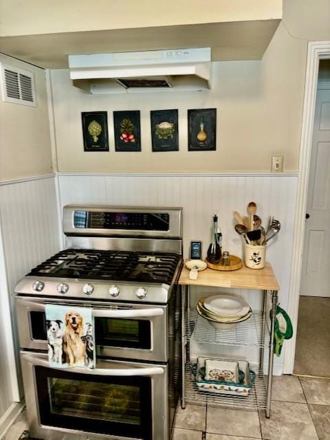 kitchen with light tile patterned flooring and double oven range