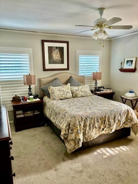 bedroom featuring multiple windows, crown molding, carpet floors, and ceiling fan