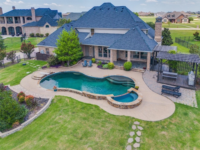 view of swimming pool featuring a patio area, an in ground hot tub, and a lawn