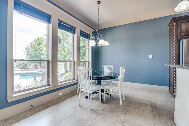 tiled dining room with plenty of natural light, crown molding, and an inviting chandelier