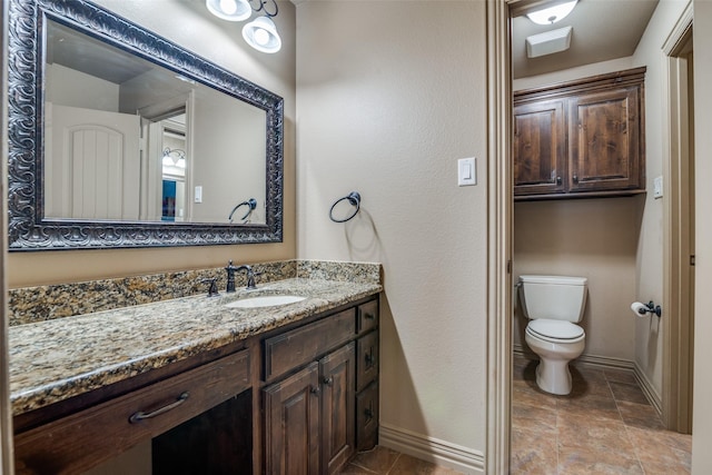 bathroom featuring toilet and vanity