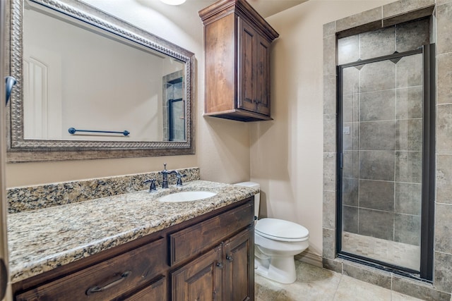 bathroom featuring toilet, vanity, and walk in shower