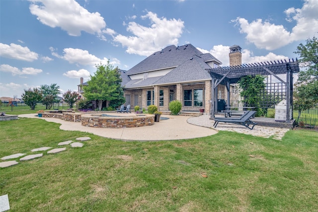 back of house featuring a lawn, a pergola, and a patio