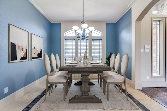 dining area featuring a chandelier and ornamental molding