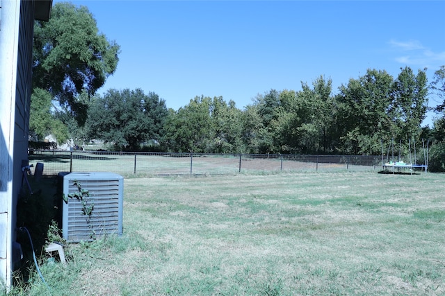 view of yard featuring a rural view and a trampoline