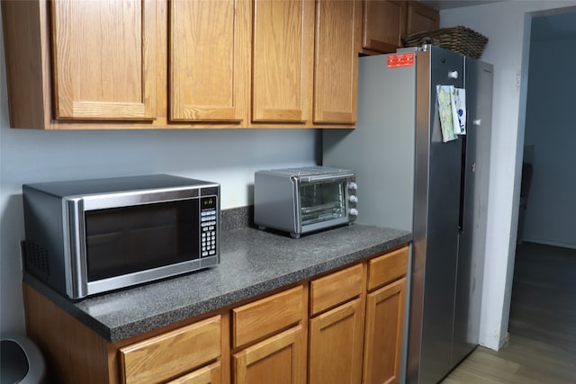 kitchen with stainless steel appliances and wood-type flooring