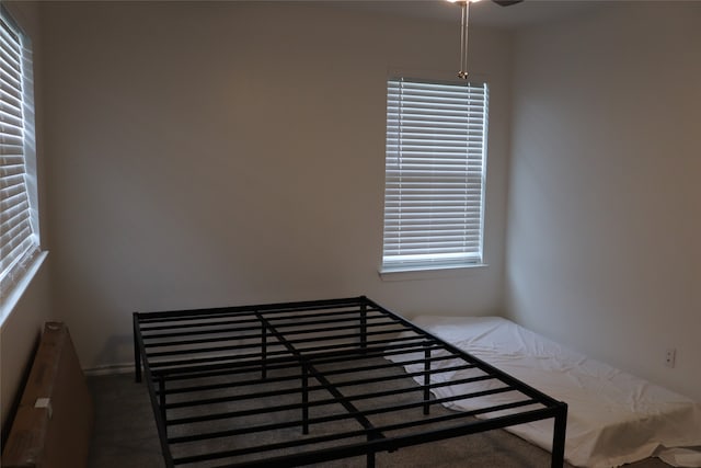 unfurnished bedroom with dark colored carpet