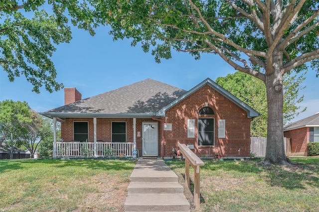 view of front of house with covered porch and a front yard