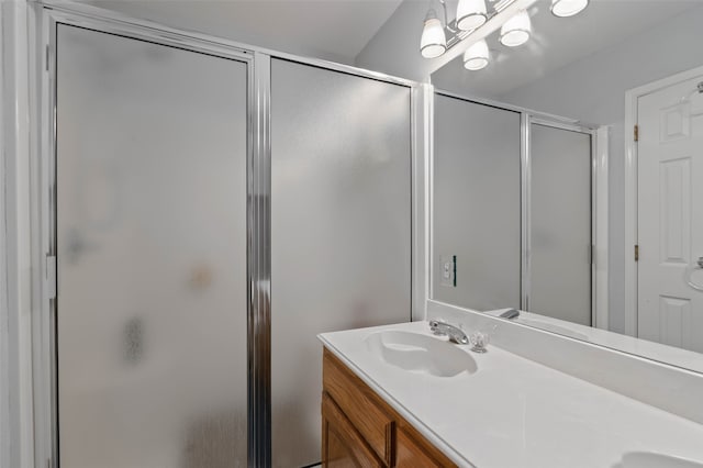 bathroom featuring vanity and a shower with door