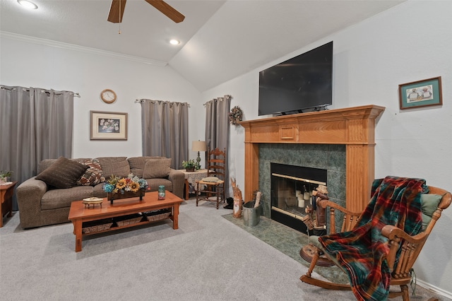 living room with carpet floors, a tile fireplace, ceiling fan, and lofted ceiling