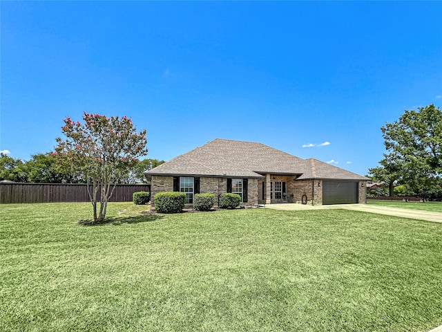 view of front of property with a garage and a front yard