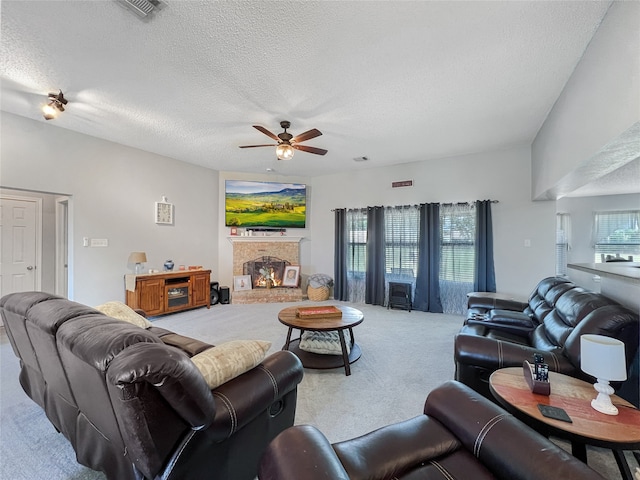 carpeted living room featuring a textured ceiling and ceiling fan