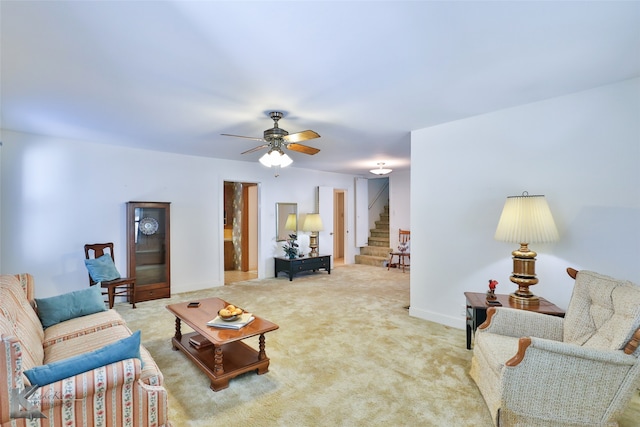 carpeted living room with ceiling fan