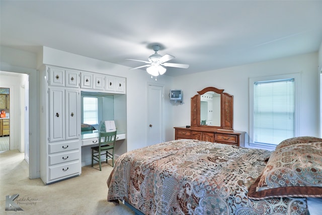 bedroom featuring ceiling fan and light colored carpet