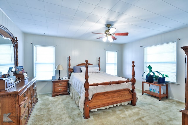 bedroom with ceiling fan and light carpet