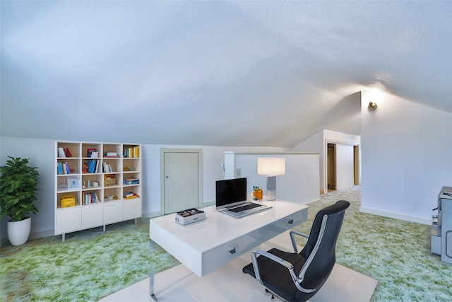 home office with light carpet and lofted ceiling