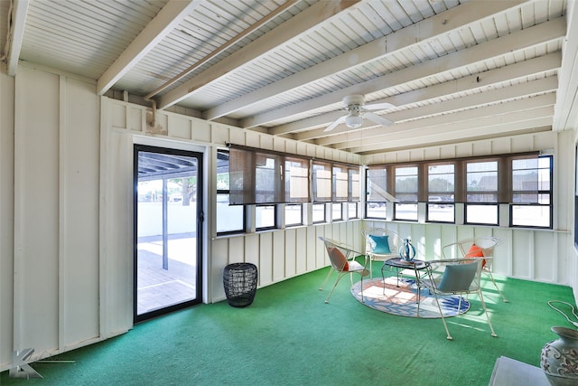 unfurnished sunroom featuring beam ceiling, ceiling fan, and a healthy amount of sunlight