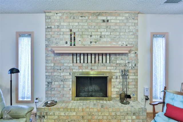 details with a textured ceiling and a fireplace