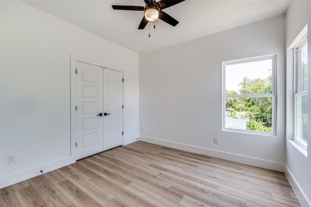 unfurnished room featuring light hardwood / wood-style flooring and ceiling fan