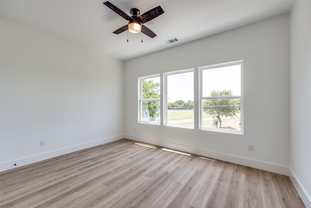 unfurnished room with ceiling fan and light wood-type flooring