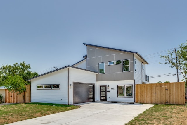 contemporary house with a garage and a front yard