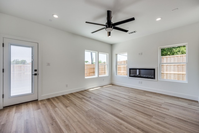 unfurnished living room with light hardwood / wood-style floors and ceiling fan