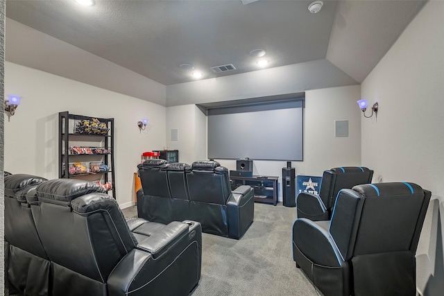 carpeted home theater featuring lofted ceiling