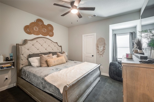 bedroom with ceiling fan and dark carpet