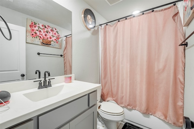 full bathroom featuring vanity, shower / bath combination with curtain, and toilet