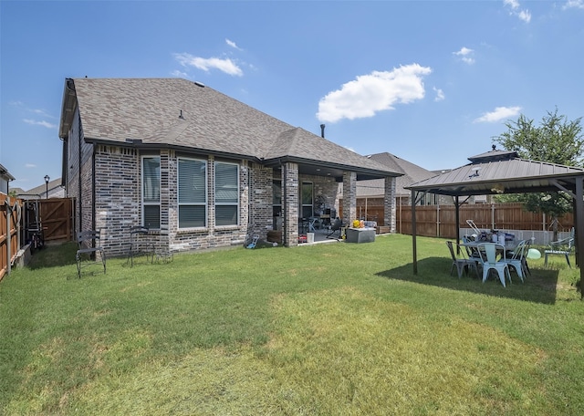 back of property featuring a gazebo, a yard, and a patio area