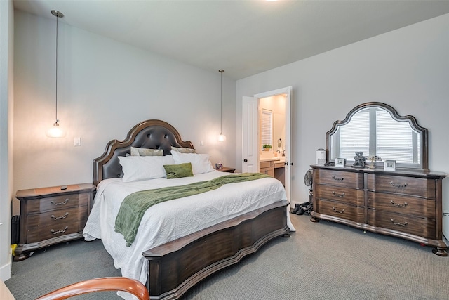 bedroom featuring ensuite bathroom and carpet