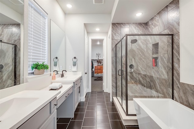 bathroom with vanity, tile patterned floors, and plus walk in shower